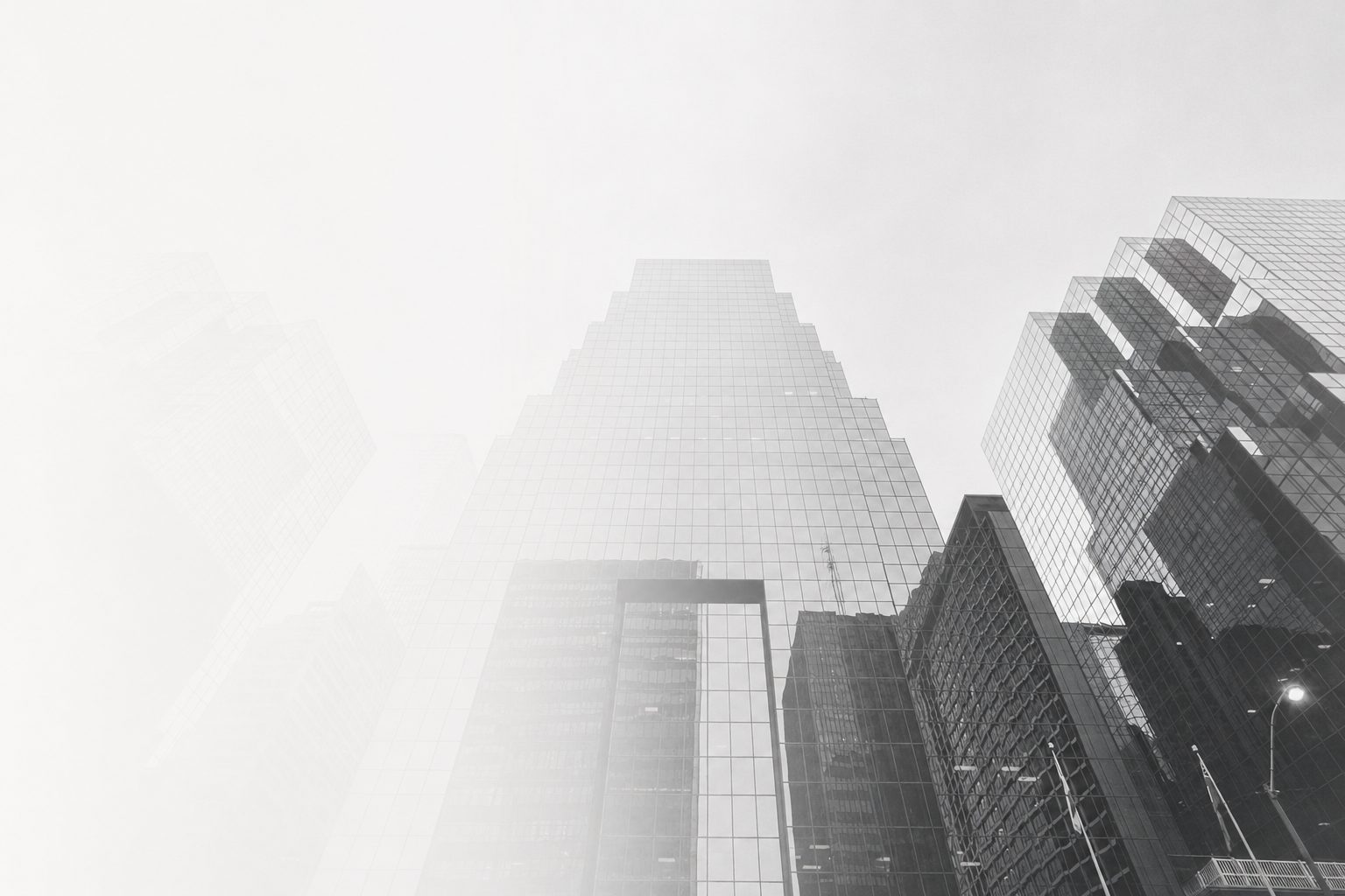 Skyscrapers rising into fog, shot looking upward